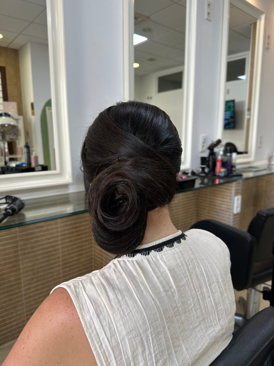 Sleek low bun updo for a special occasion near Puerto Banus, Marbella