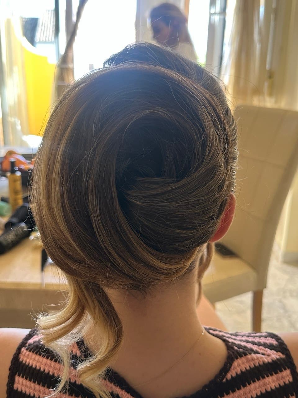 Sleek twisted updo created during an on-location styling appointment